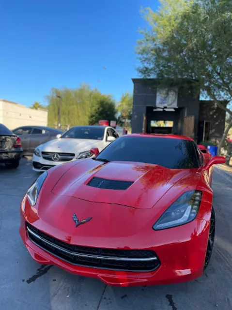 Red Chevrolet Corvette Stingray photographed from the front on an Arizona lot